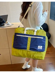 Detailed view of large color-block travel bag featuring a DUANGBAGS logo patch detail