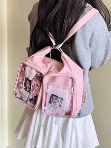 Detail view of pink Harajuku style star-patterned Ita-bag with clear windows on model