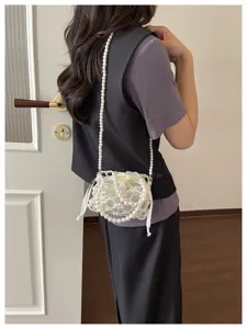 Chic pearl beaded crossbody bag for women, elegant hollow phone bag and stylish daily purse.