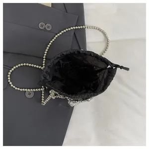 Detailed view of a stylish black drawstring bag featuring a shiny silver beaded chain strap.