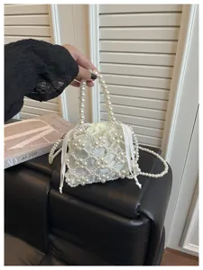 Elegant pearl beaded handbag, chic hollow out shoulder bag and fashion phone pouch for daily use.