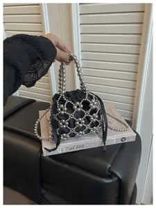 Stylish beaded bucket bag with metallic silver spheres, black satin pouch, and chic ribbon bow.