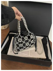 Close-up detail of the stylish silver beaded mesh handbag with black inner pouch and chain.