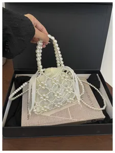 Elegant white pearl beaded handbag with drawstring inner pouch and chic chain strap design.