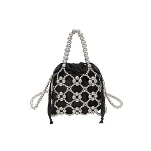Detailed view of black pouch with silver beaded mesh cage, elegant handle and chain strap.