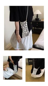 Detailed lifestyle view of a woven macrame phone bag with tassels and shell accents