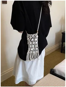 Lifestyle view of a white bohemian woven fringe phone bag for daily crossbody wear
