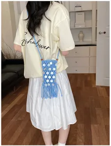 Bohemian blue woven mobile phone bag with sequins and fringe detail, lifestyle view