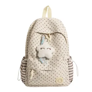 Detailed view of the cute star patterned school backpack featuring a fluffy star charm and side pockets.