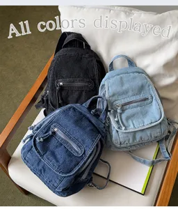 Group shot of three small denim backpacks in black, light blue, and dark blue colors