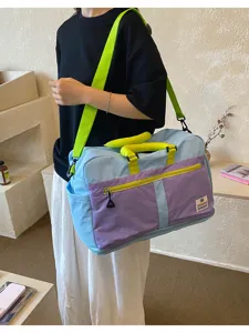 Large capacity color-block outdoor travel bag with neon green strap and purple accents
