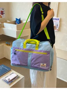 Large capacity color-block outdoor travel bag shown in a lifestyle shop setting