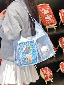 Close-up of a blue star-patterned ita bag with anime merchandise displayed in windows