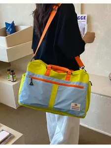 Fashionable color-block outdoor travel bag with large capacity shown in a lifestyle scene