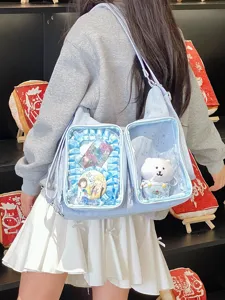 Detailed view of a light blue star-printed Ita bag featuring dual clear display compartments.