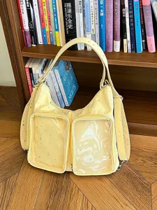 Macro view of yellow Harajuku style Ita bag featuring transparent windows and star patterns