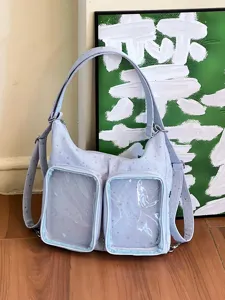 Detail of blue star pattern ita bag with two clear display windows for accessories.