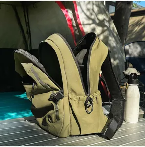 Vue détaillée des compartiments et de la texture d'un sac à dos de voyage vert clair