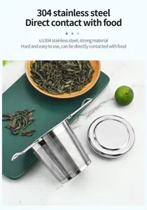 Infuseur à thé en acier inoxydable gros plan avec filtre fin et poignées pliantes.