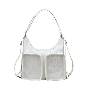 Detailed view of white hobo bag with star pattern and clear front pockets