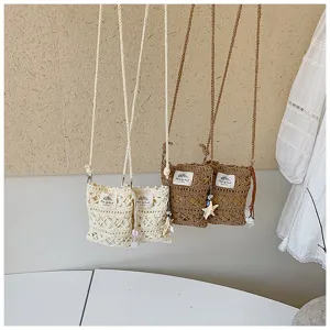 Detailed view of handmade hollow crochet crossbody phone bags with starfish charms.