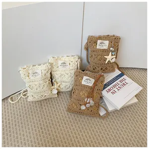 Detail of hand-knitted hollow mobile phone bags with starfish pendants in fresh style.