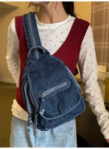 Detailed view of a model wearing a multi-functional blue washed denim chest bag for women