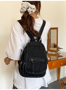 Vintage black washed denim backpack with multiple zippers for commute and travel