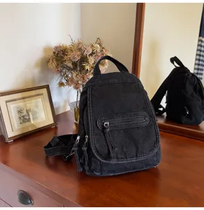 Detailed macro view of vintage black washed denim multi-functional mini backpack