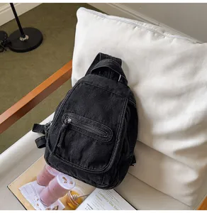 Vintage washed black denim multi-functional chest bag for women in a lifestyle setting