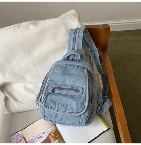 Close-up of vintage washed denim small backpack for women in a lifestyle setting