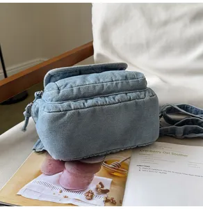 Detail showing texture of retro washed denim women's multi-functional chest bag backpack