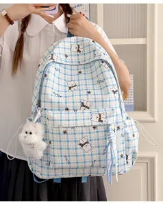 Cute light blue plaid student backpack featuring cartoon bear prints and plush dog charm