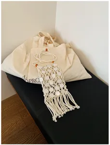 Detailed view of handmade woven phone bag featuring shell sequins and long tassels