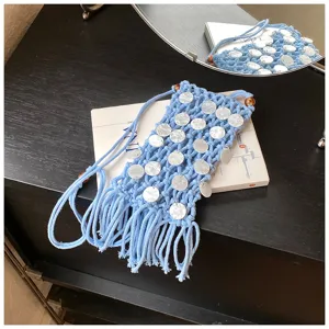 Close-up of blue macrame phone bag with white sequins and stylish fringe detail