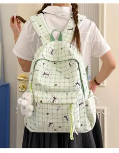 Green plaid student backpack featuring a cute cartoon bear pattern and plush keychain