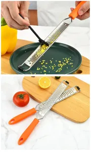 Stainless steel cheese grater lemon zester with orange handle and cleaning brush for kitchen.