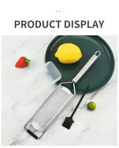 Ensemble de râpe à citron et fromage en acier inoxydable avec couvercle et petite brosse.