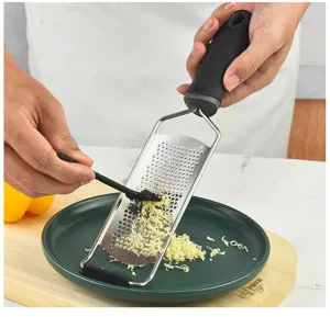 Durable stainless steel cheese grater with non-slip handle for easy kitchen food grating.