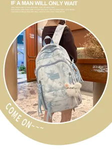 Lifestyle view of a blue and white tie-dye large capacity backpack for students.