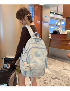 Side view detail of a stylish tie-dye large capacity school backpack worn by a model