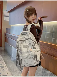Close-up of the stylish tie-dye large capacity backpack worn by a student model
