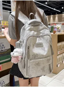 Back view of a large capacity school backpack with a cute bear print and dog charm