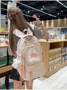 Detailed view of stylish pink and white tie-dye backpack for students in lifestyle setting