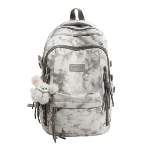 Close-up view of a large grey tie-dye backpack with a cute white plush mascot detail