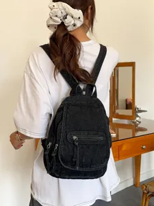 Vintage black washed denim backpack for women featuring multiple zipper pockets