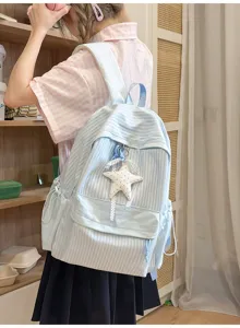 Detailansicht eines hellblau gestreiften Schülerrucksacks mit süßem Sternenanhänger