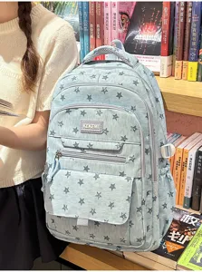 Light blue star pattern high-capacity school backpack shown in a lifestyle bookstore setting
