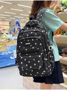 Back view of a black star pattern backpack worn by a student in a store.