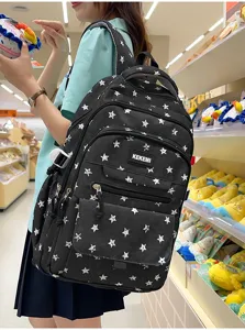 Close-up of black star-patterned school backpack worn by a student in a store setting